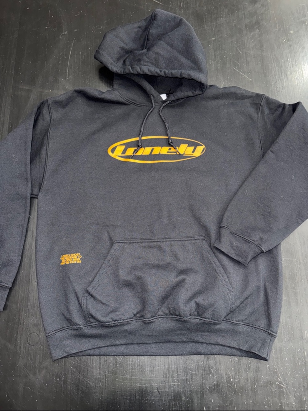 LONELY GHOST black hoodie. size large. lonely print in orange. like new.